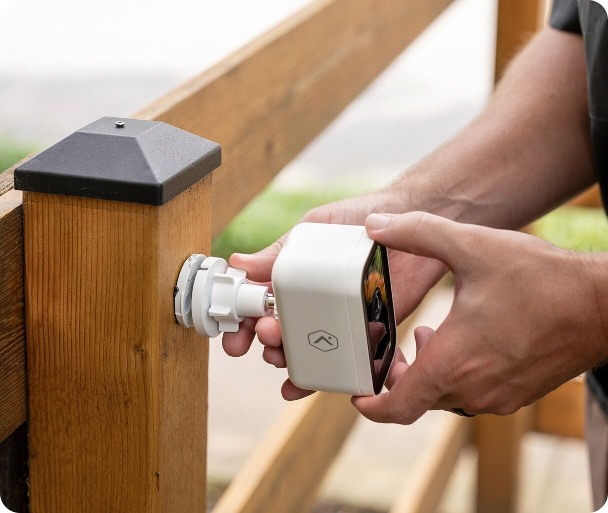Hands installing outdoor camera