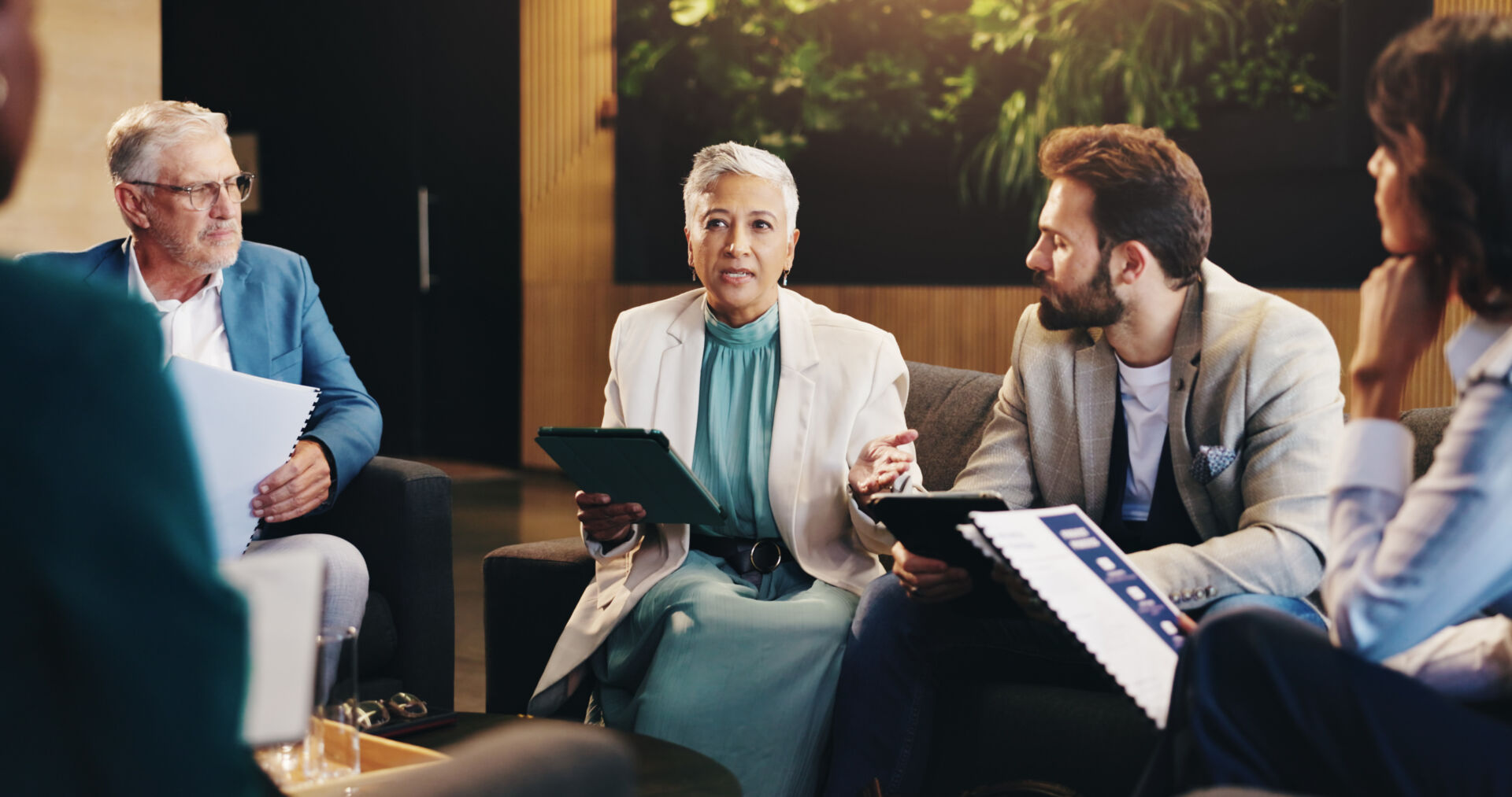 Business people, meeting and planning in workplace, conversation and brainstorming for creative project. Group, employees and leader in office, teamwork and feedback for ideas, talking and proposal.