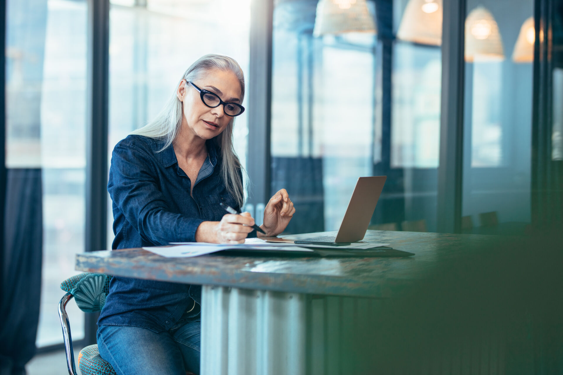woman using a laptop sitting at a desk