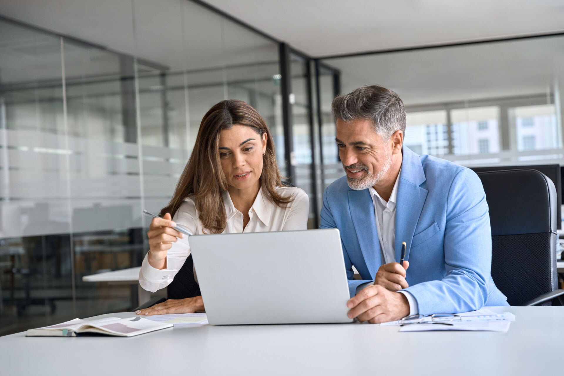 Two people looking at a laptop screen
