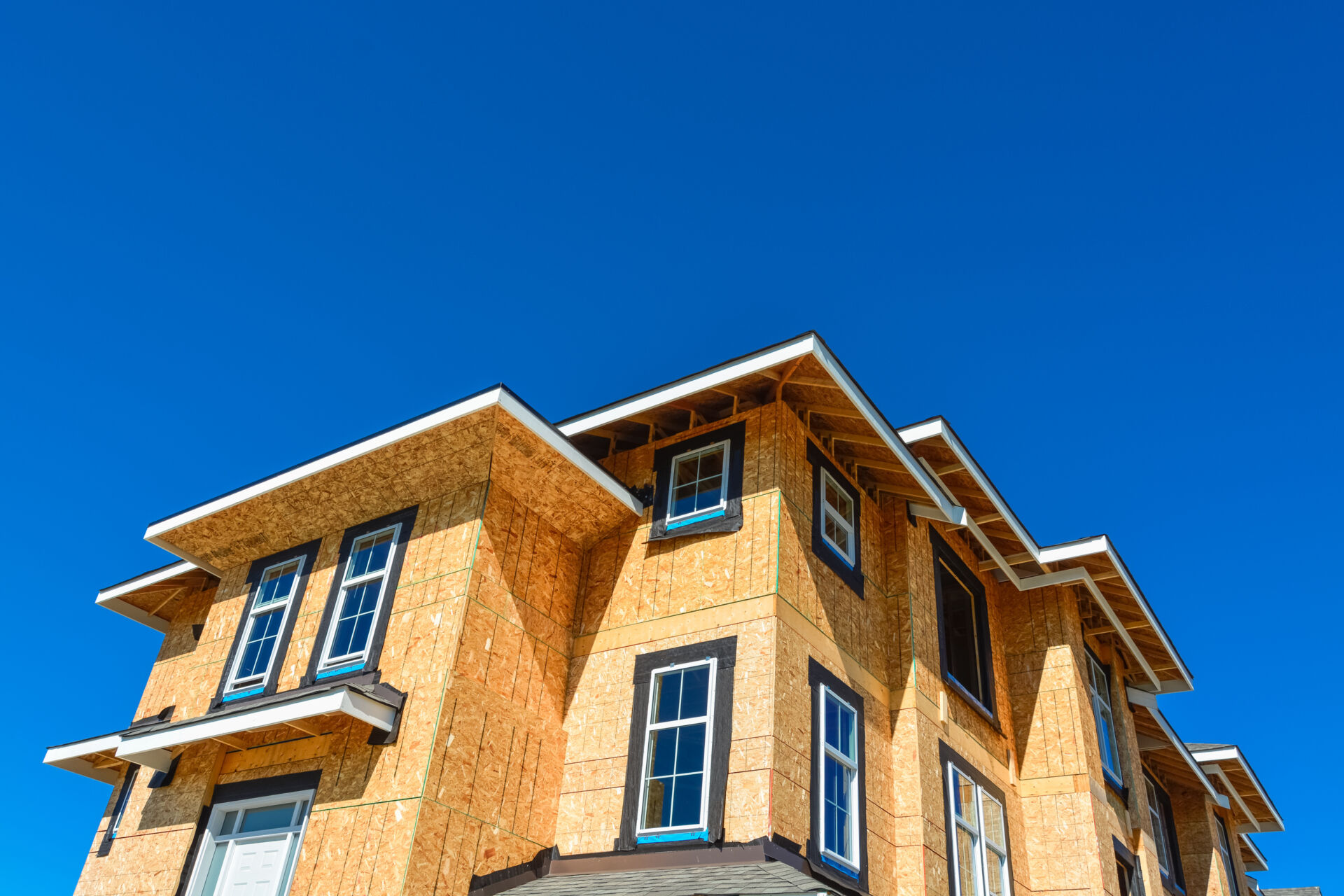 Brand new townhouses building under construction on sunny day in British Columbia, Canada.