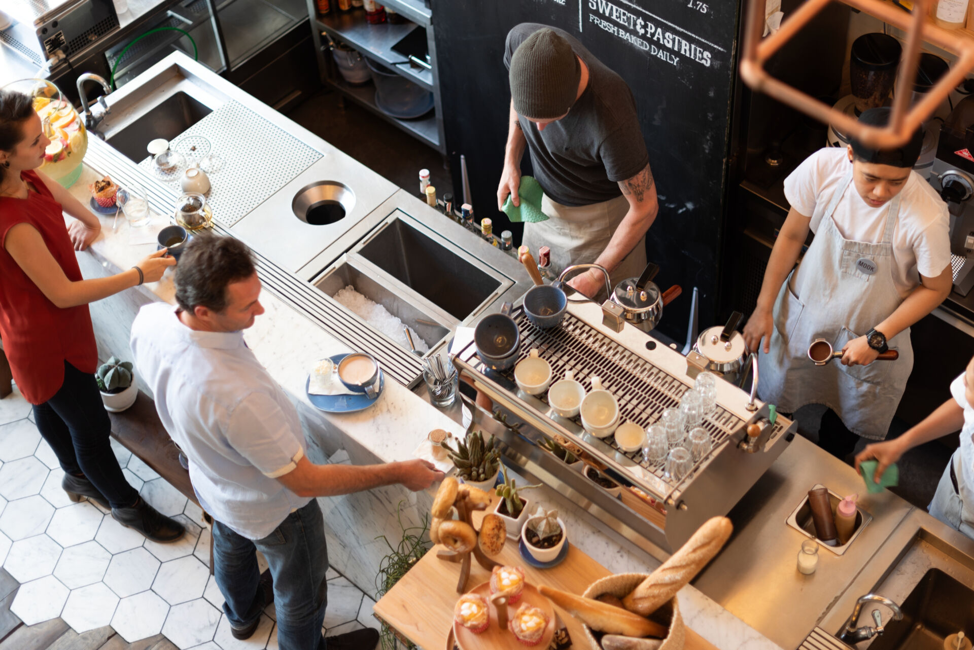 Staff working in a commercial kitchen at one of several locations grouped by region and district