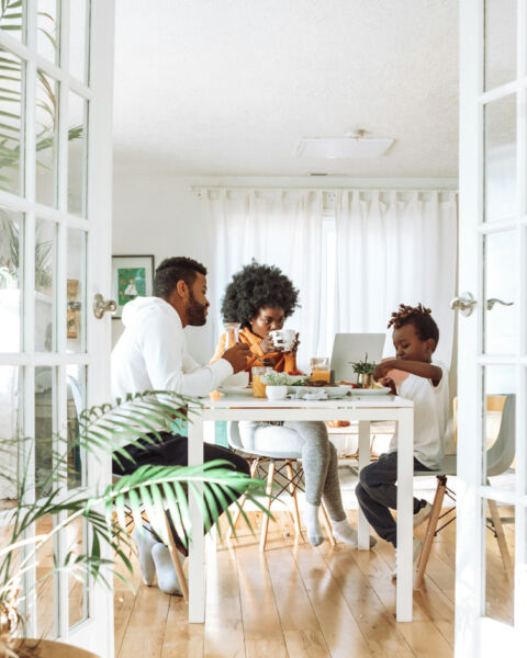 Family eating at a dining table, seen through open French doors with a camera mounted above
