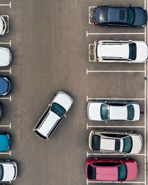The only vacant parking space in parking lot. Navigation in the car park. Searching for vacant space for parking. The parking is jammed with cars. problem. Finding a vacant place.