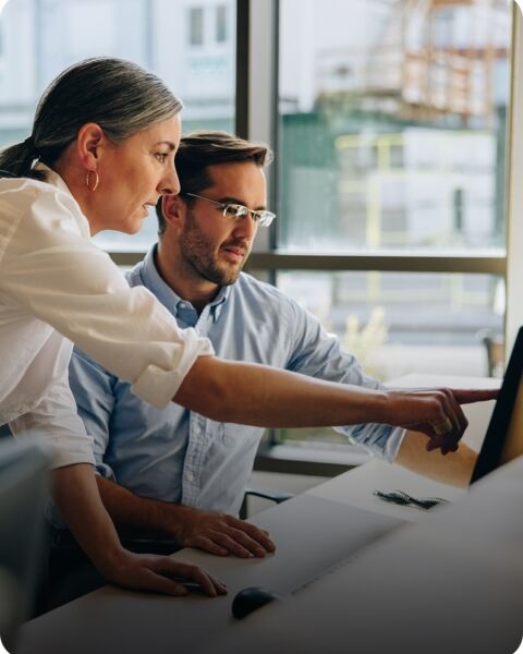 Colleagues working at desk in office