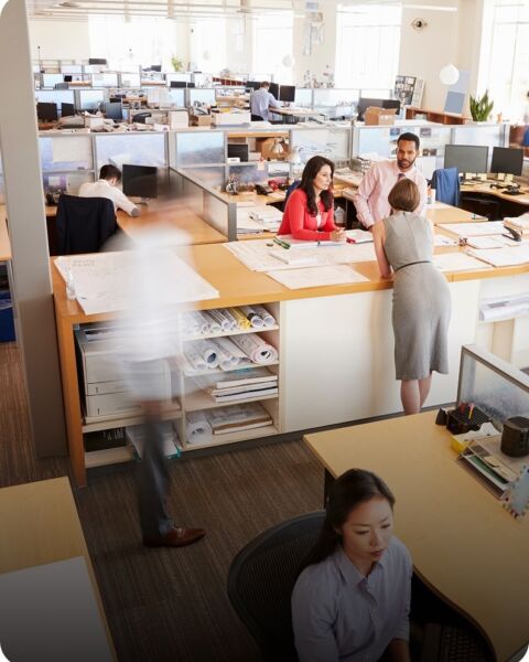 Employees working at desks in an open-plan office
