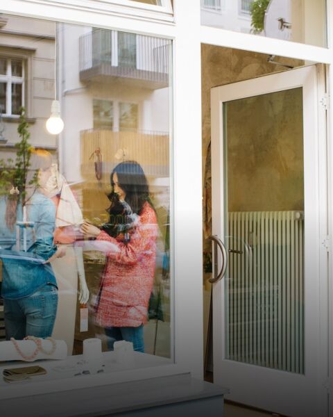 Customers entering a retail store through a glass storefront door