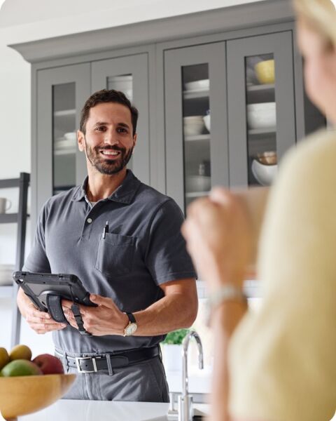 Technician smiling tablet kitchen