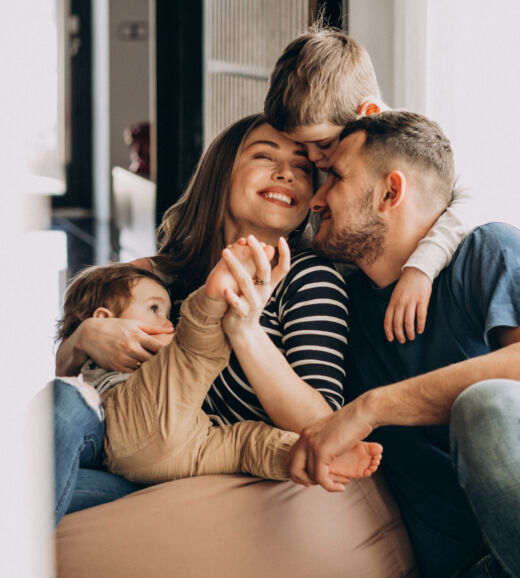 Young family with their sons at home having fun