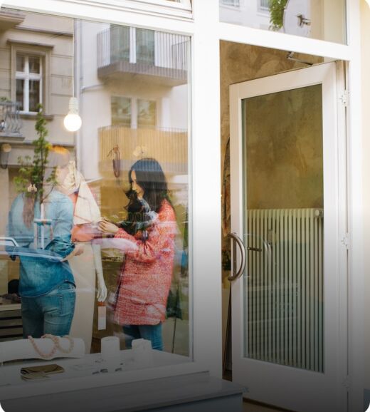 Customers entering a retail store through a glass storefront door