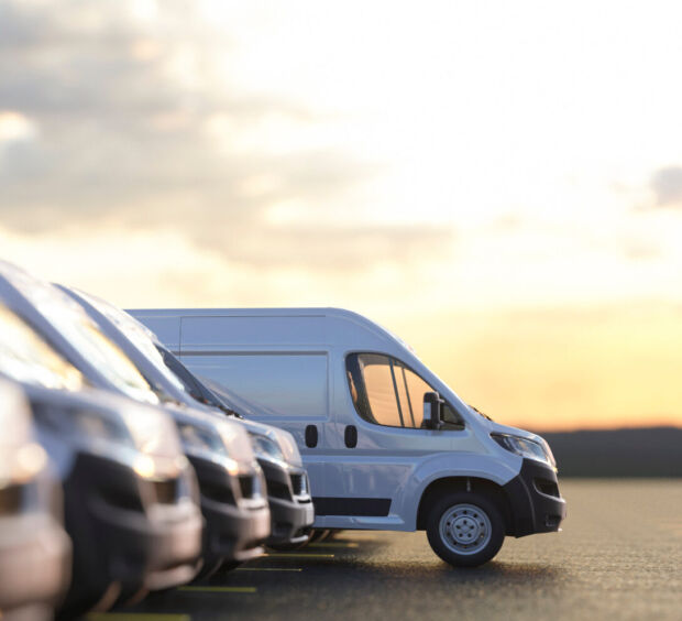 Commercial fleet van parked outside a facility at sunset