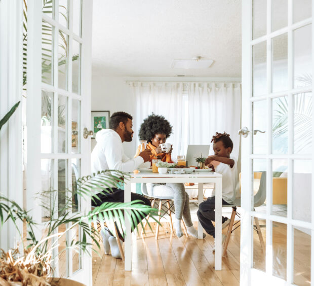 Family eating at a dining table, seen through open French doors with a camera mounted above