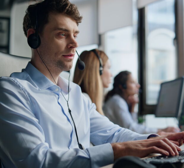 Professional support representative man talking headset helping customer remotely.