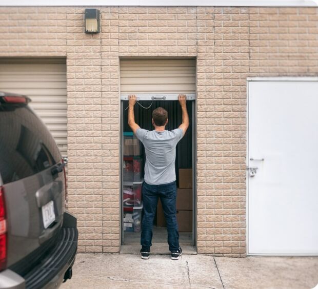 Employee lifting a roll-up loading door