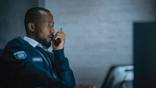 Security guard talking on a walkie talkie