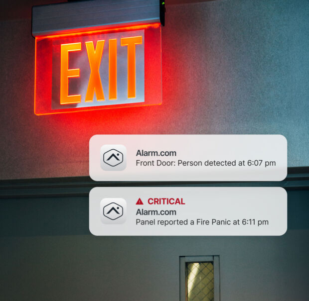 Illuminated emergency exit signIlluminated emergency exit sign in a commercial corridor with fire and security alerts monitored in one view
